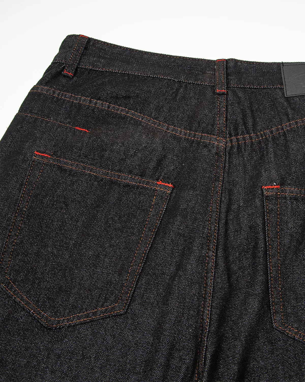 Asymmetric buckle raw baggy jeans by INFLATION featuring loose fit, distressed details, and unique buckle accents in streetwear style.