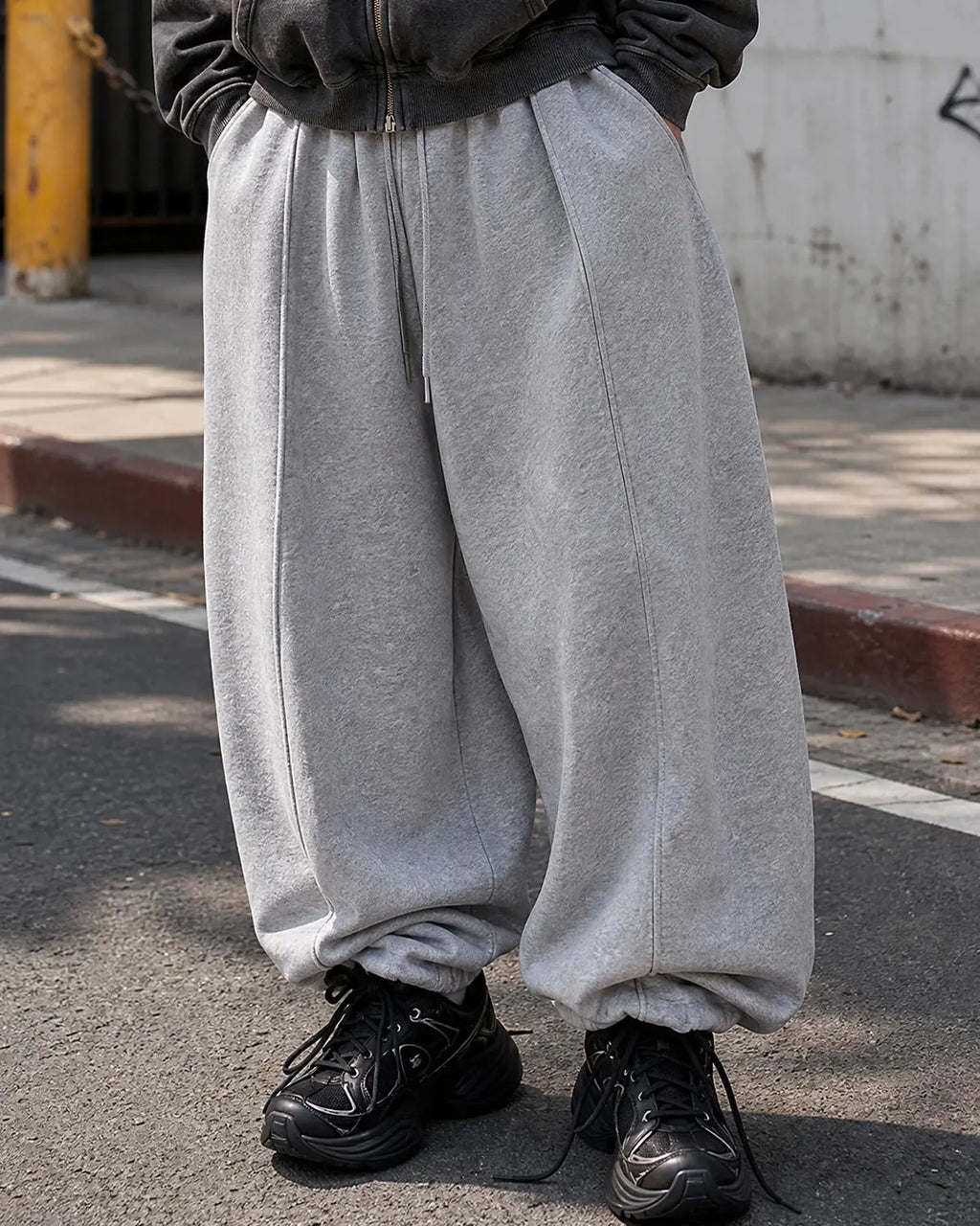 Grey baggy jogger sweatpants from Inflation Streetwear with a relaxed fit and elastic waistband, casual streetwear style.
