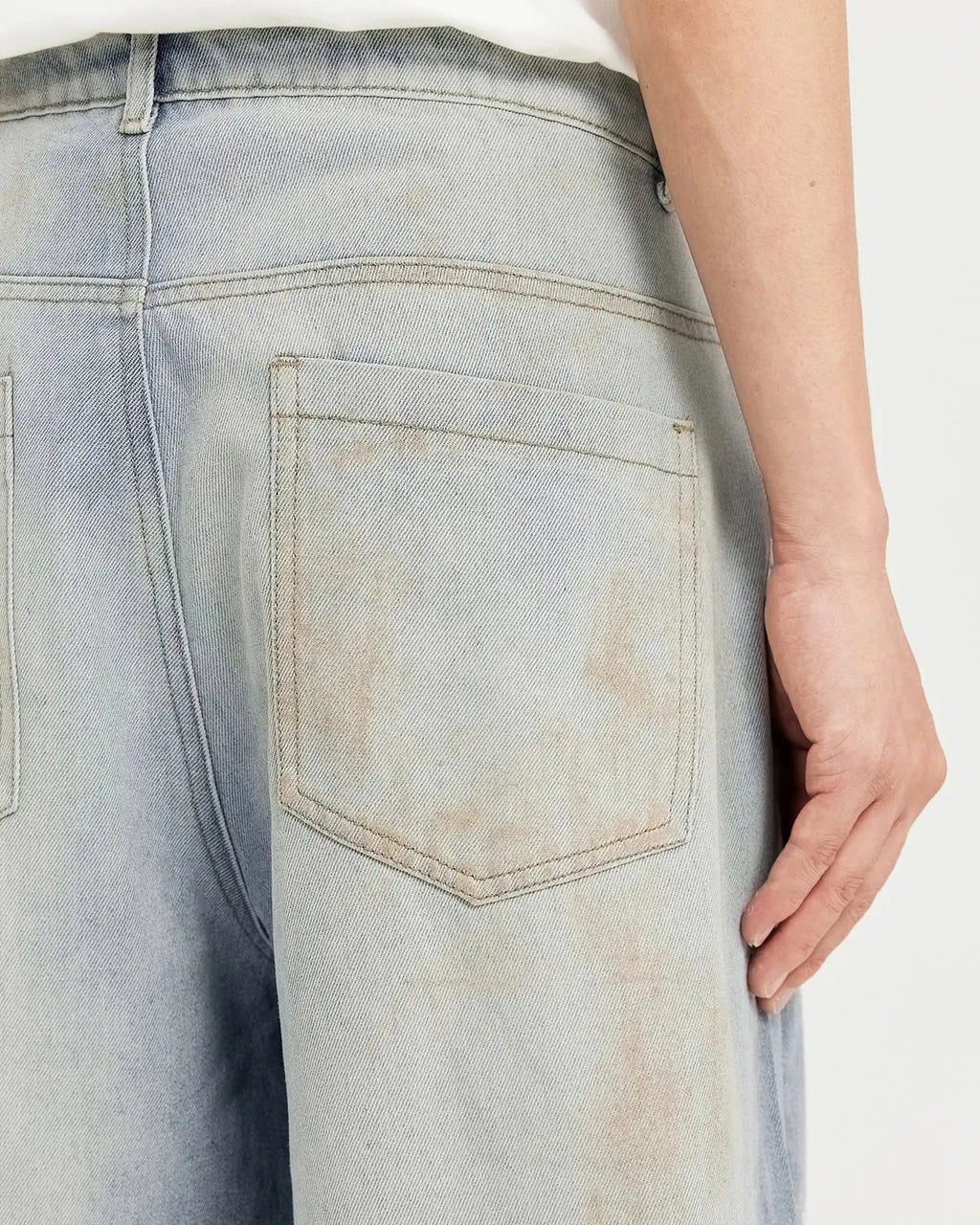 Mud washed baggy jeans by Flation Streetwear featuring a relaxed fit, faded denim texture, and casual streetwear style.
