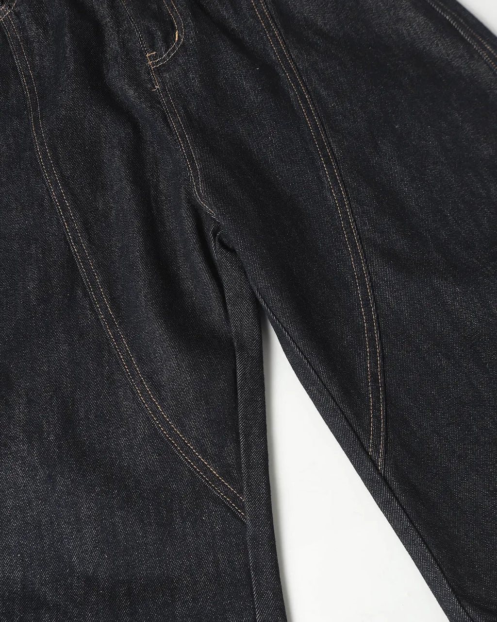 Deconstructed scimitar denim longline jorts by INFLATION, featuring distressed details and a relaxed fit, worn as stylish streetwear pants.