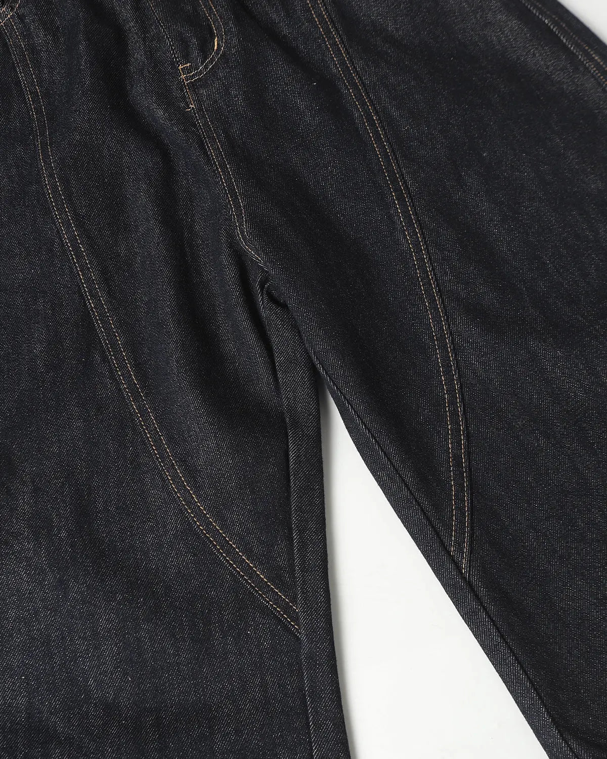 Deconstructed scimitar denim longline jorts by INFLATION, featuring distressed details and a relaxed fit, worn as stylish streetwear pants.