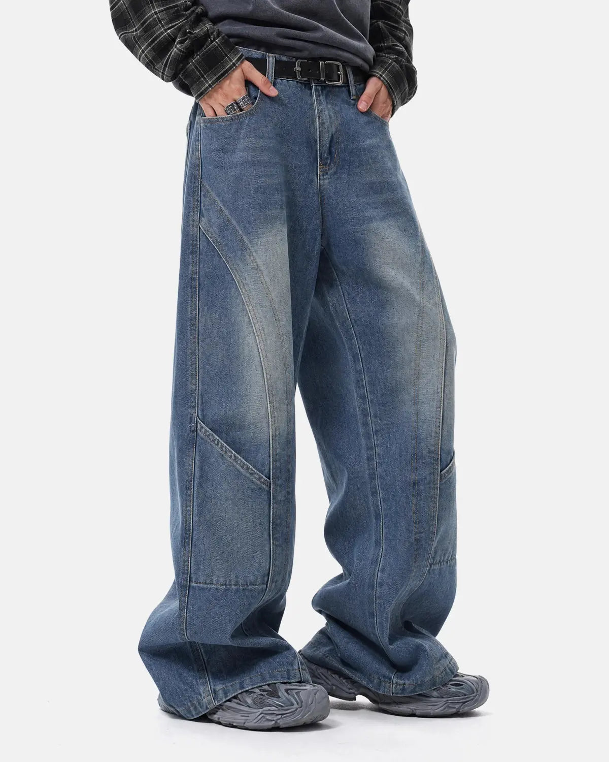 Deconstructed baggy straight-leg jeans by INFLATION Streetwear, showing relaxed fit with detailed distressed and raw hem design.