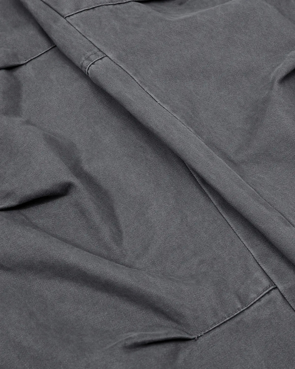 Washed curved seam cargo pants by INFLATION, streetwear style with relaxed fit and multiple pockets on durable fabric.