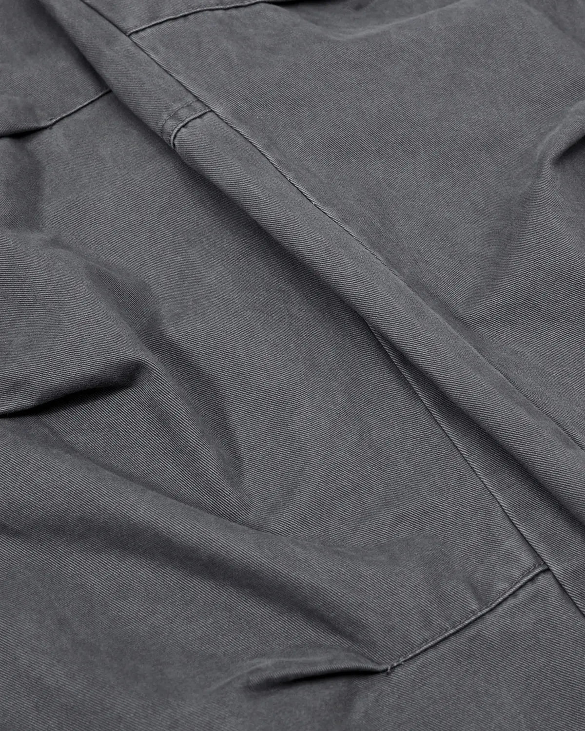 Washed curved seam cargo pants by INFLATION, streetwear style with relaxed fit and multiple pockets on durable fabric.
