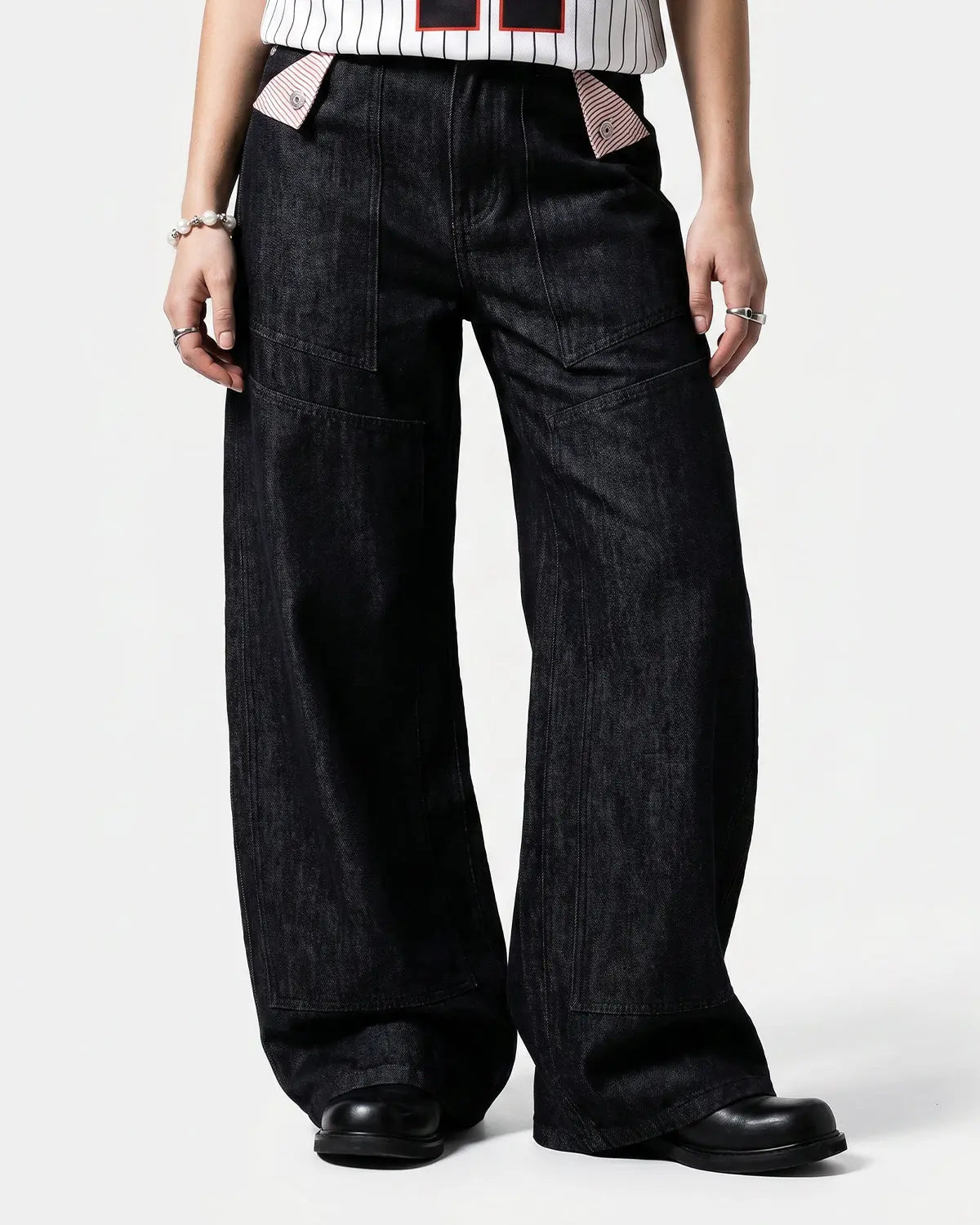Deconstructed utility baggy jeans by INFLATION featuring loose fit, multiple pockets, and distressed denim details.