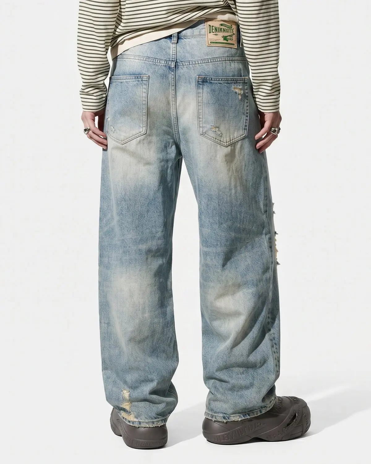 Inflation brand distressed ripped straight-leg jeans showing frayed hems and torn knees, casual streetwear pants for a trendy look.