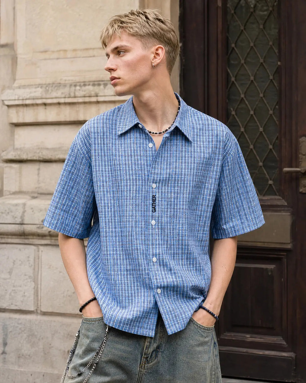 Inflation Streetwear plaid script embroidered short-sleeve shirt with a colorful checkered pattern and embroidered branding on the chest.