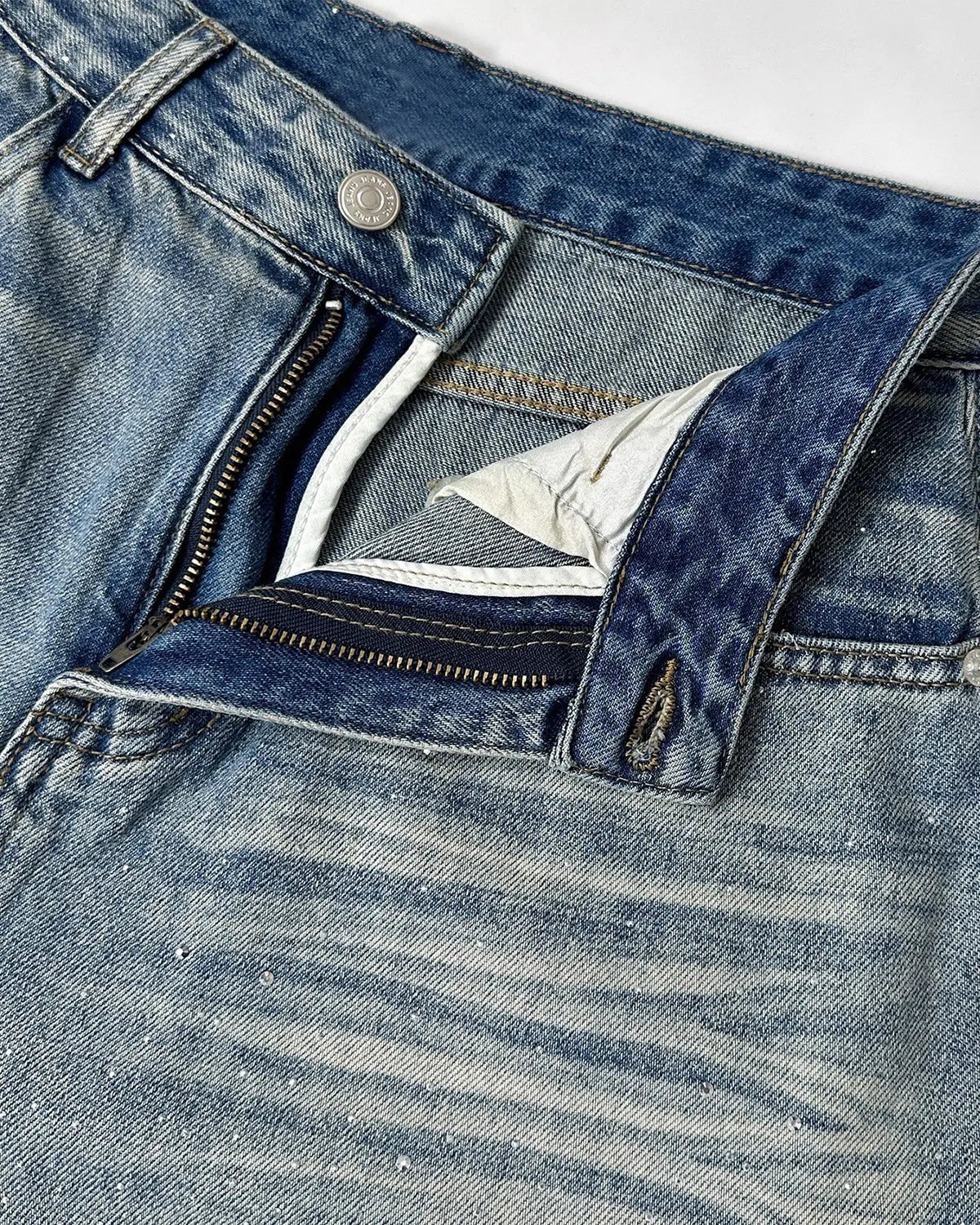 Inflation brand rhinestone washed barrel baggy jeans, men's streetwear pants with distressed denim and rhinestone details.
