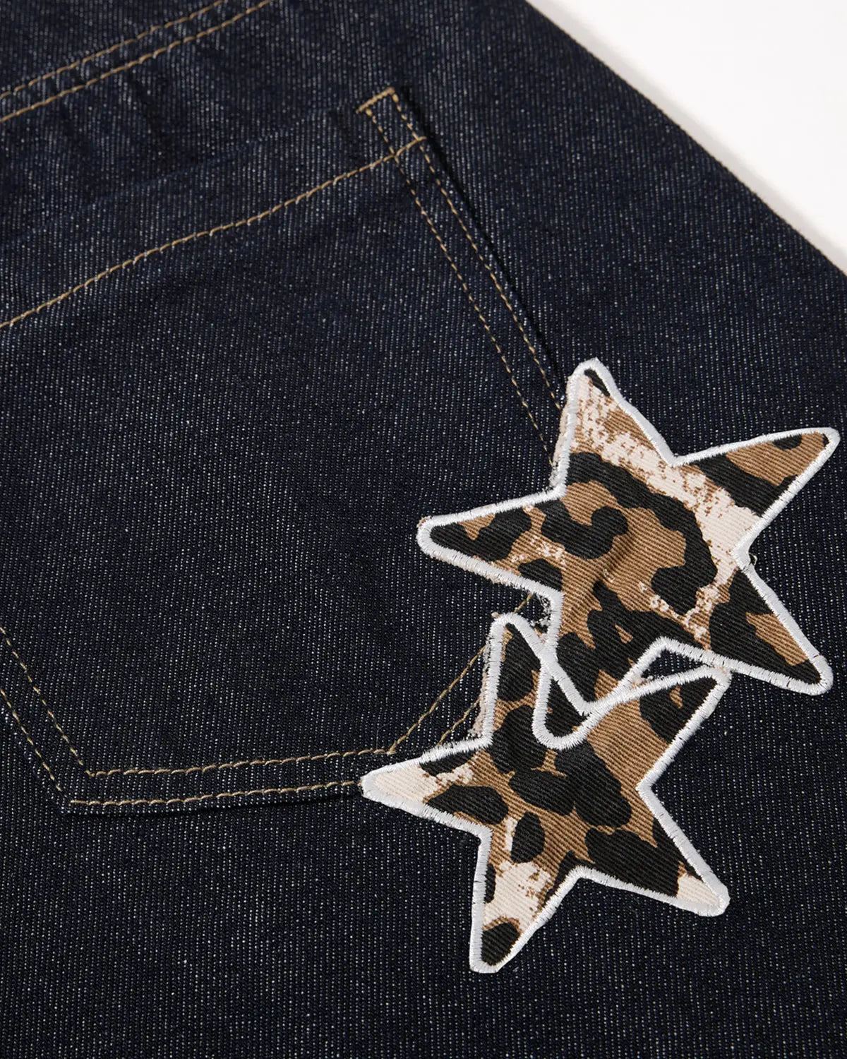 Inflation Leopard Star Patch Barrel Jeans featuring bold star patches and relaxed fit, stylish streetwear denim pants.