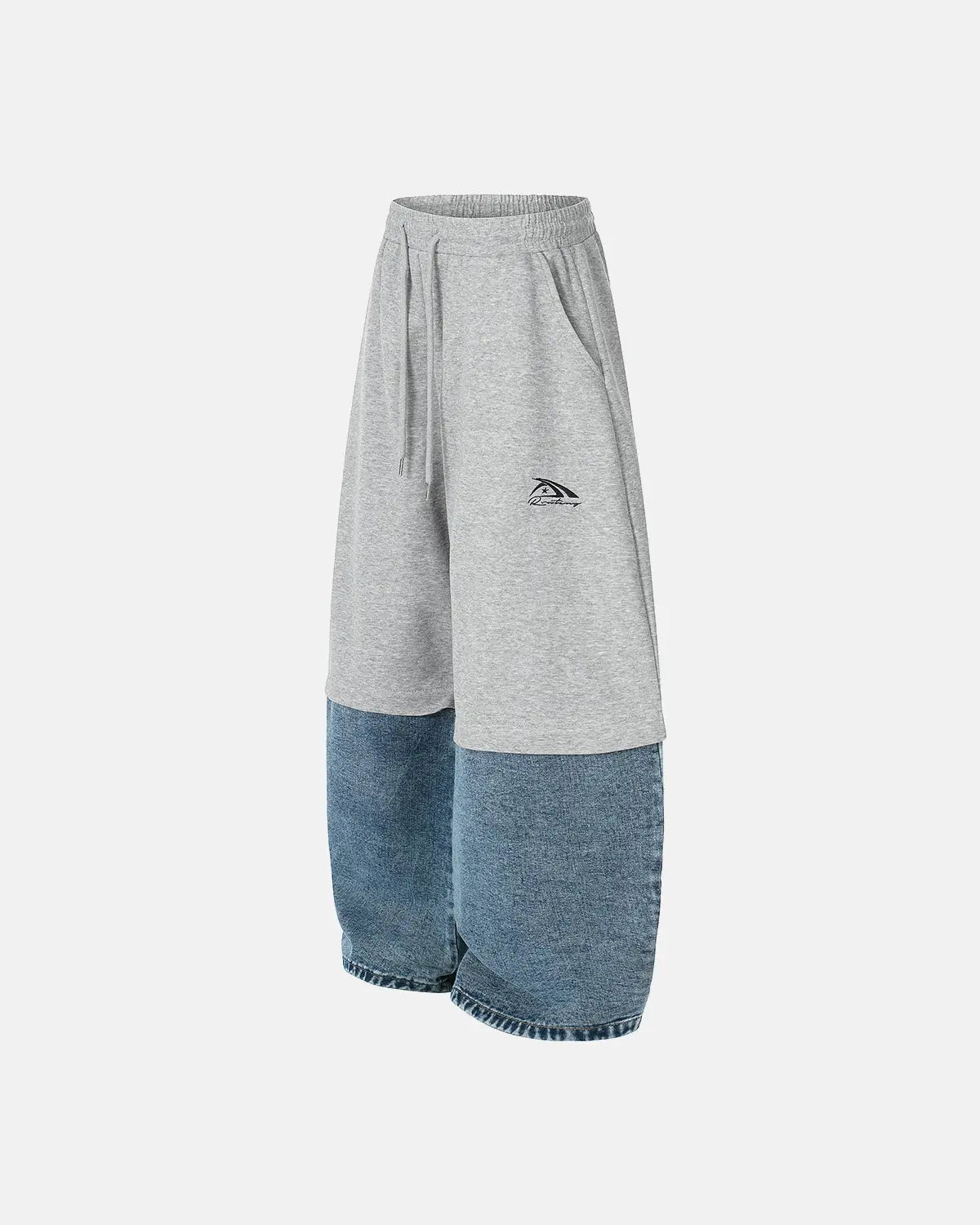 Denim detachable patchwork barrel joggers by INFLATION featuring unique patchwork design and tapered fit.