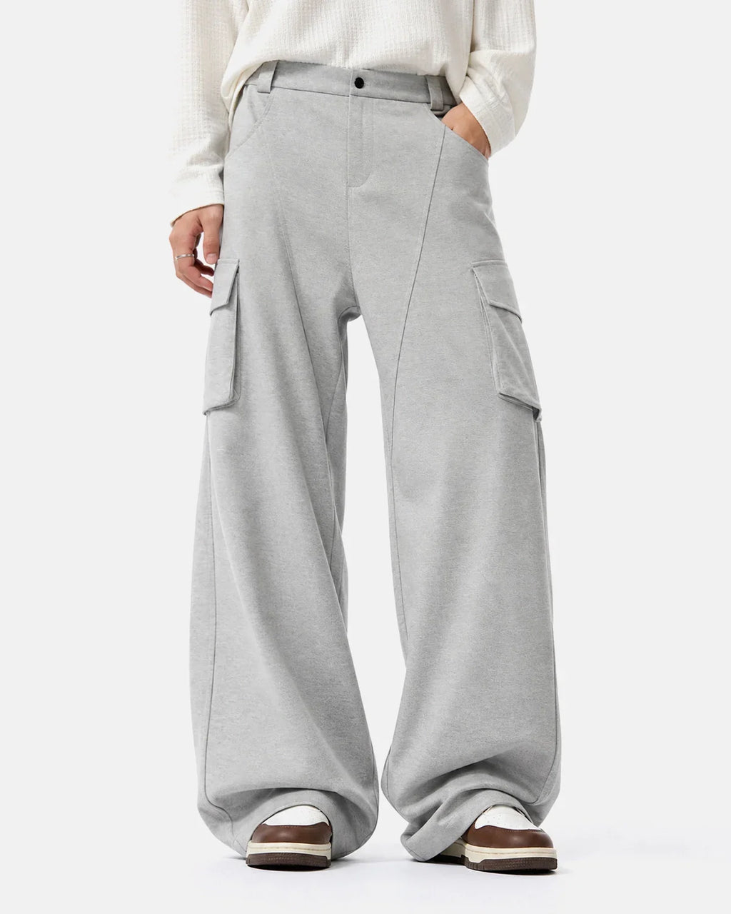 Structured wide leg cargo pants by INFLATION with multiple pockets and a relaxed fit, showcased in a neutral color.
