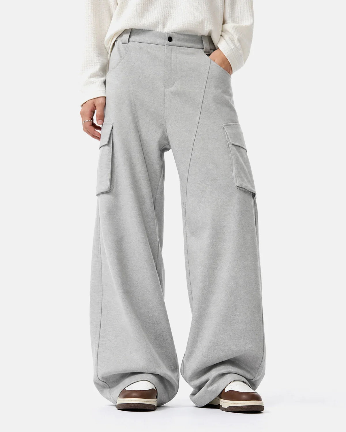 Structured wide leg cargo pants by INFLATION with multiple pockets and a relaxed fit, showcased in a neutral color.
