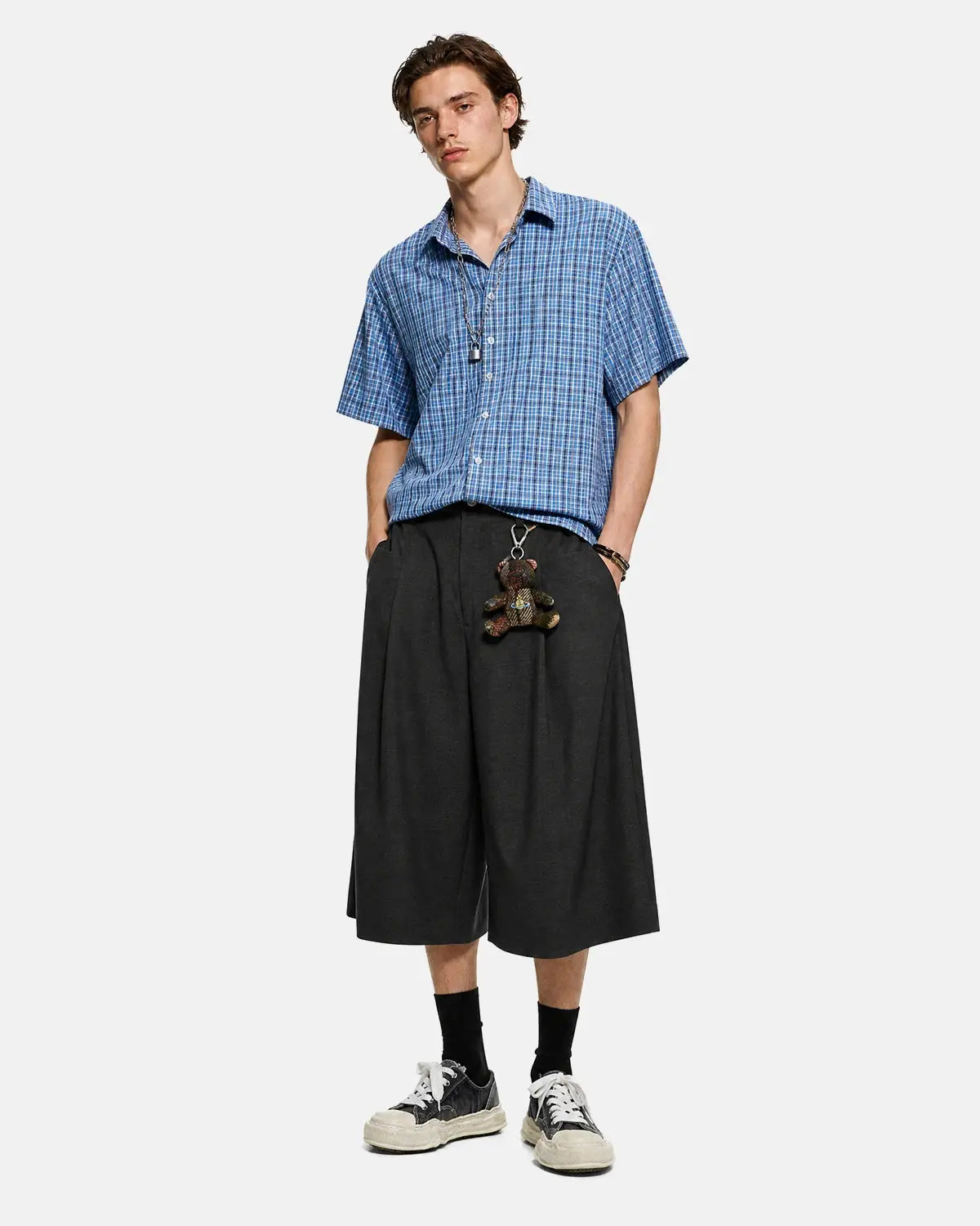 Inflation Streetwear pleated wide-leg tailored shorts in neutral fabric, featuring a high waist and relaxed fit.