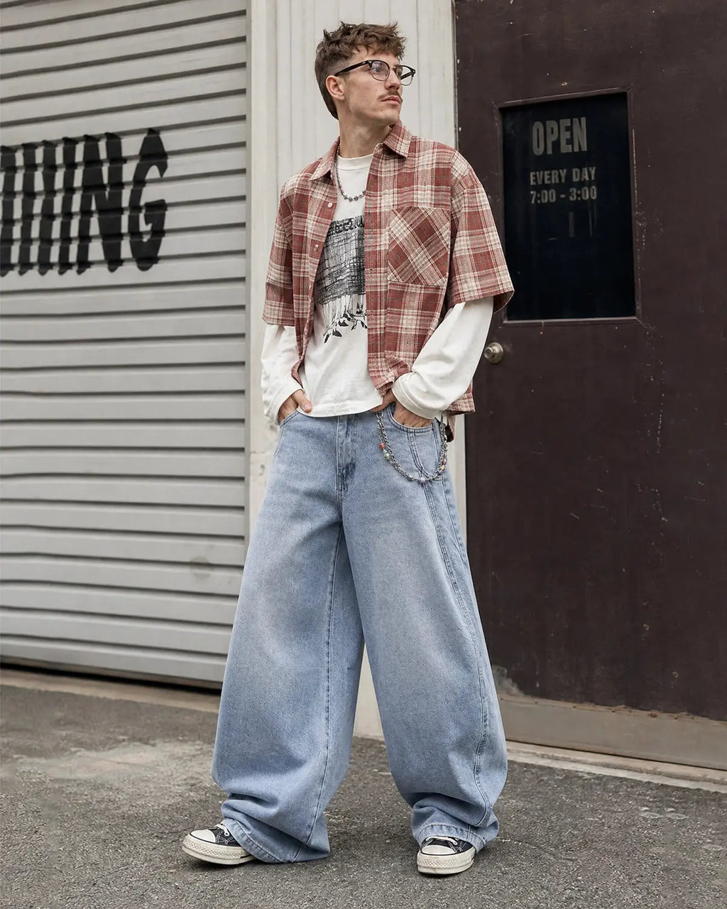 Flation acid washed distressed barrel jeans, streetwear style, showing the faded fabric, rips, and relaxed fit design.