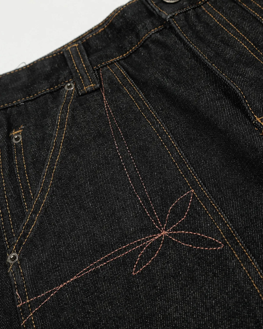 Raw embroidery Baggy Jeans by INFLATION, featuring distressed details and a relaxed fit, styled with casual streetwear vibe.