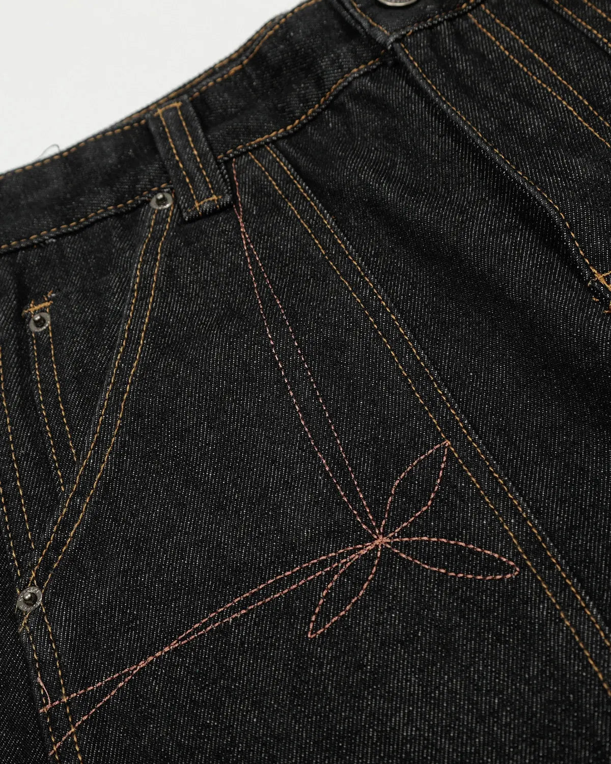 Raw embroidery Baggy Jeans by INFLATION, featuring distressed details and a relaxed fit, styled with casual streetwear vibe.