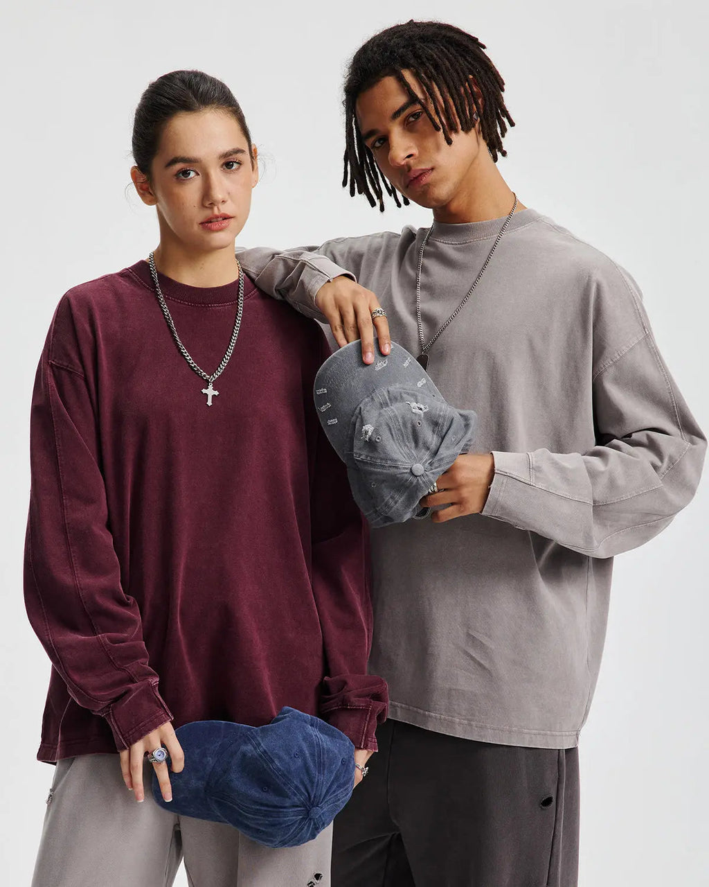 Distressed acid wash oversized long sleeve tee by Flation streetwear, shown in light blue with rips and frayed edges.