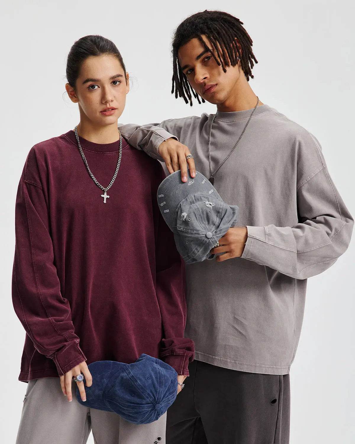 Distressed acid wash oversized long sleeve tee by Flation streetwear, shown in light blue with rips and frayed edges.