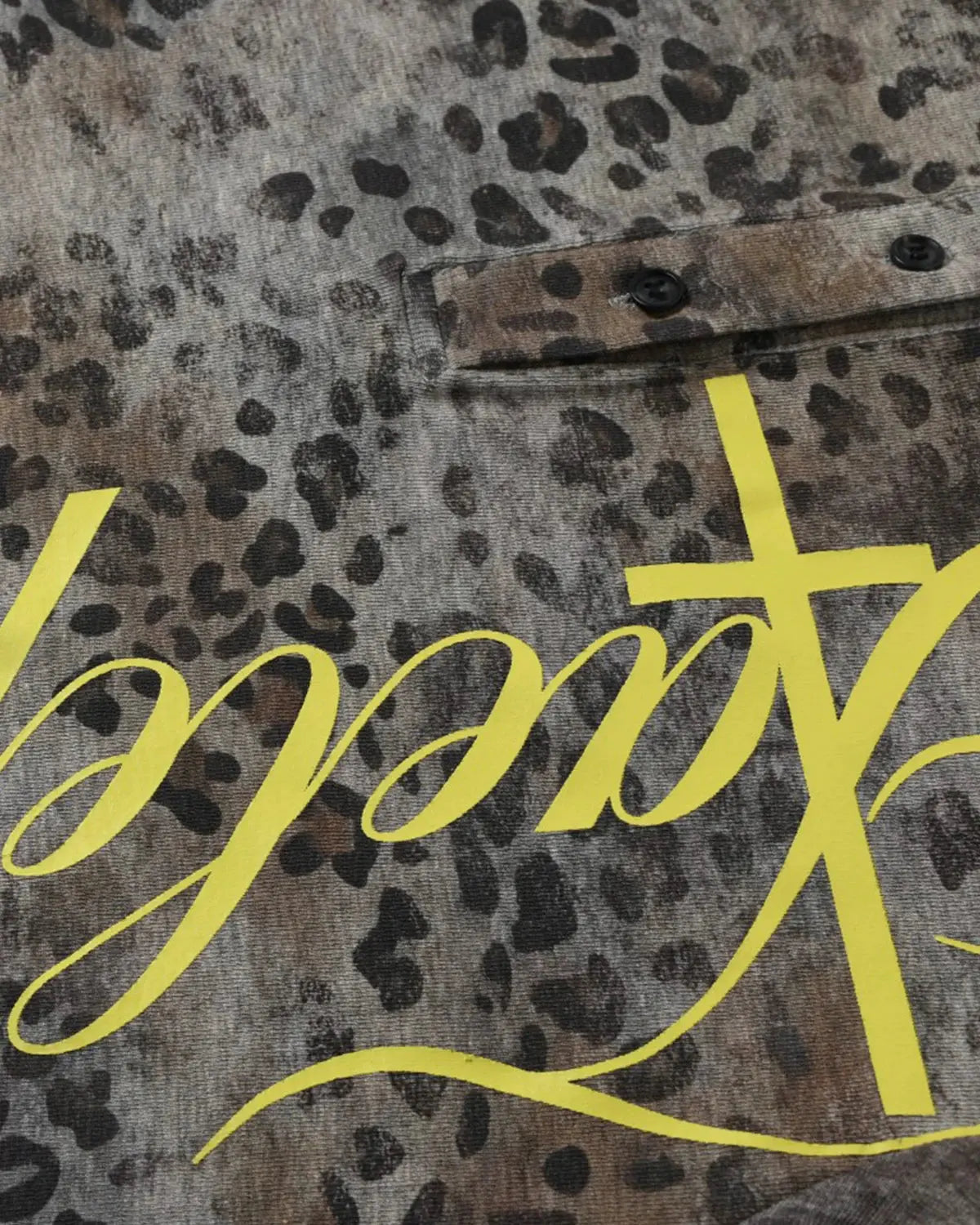 Leopard Script Henley baby tee by INFLATION featuring a leopard print and button placket on soft fabric.