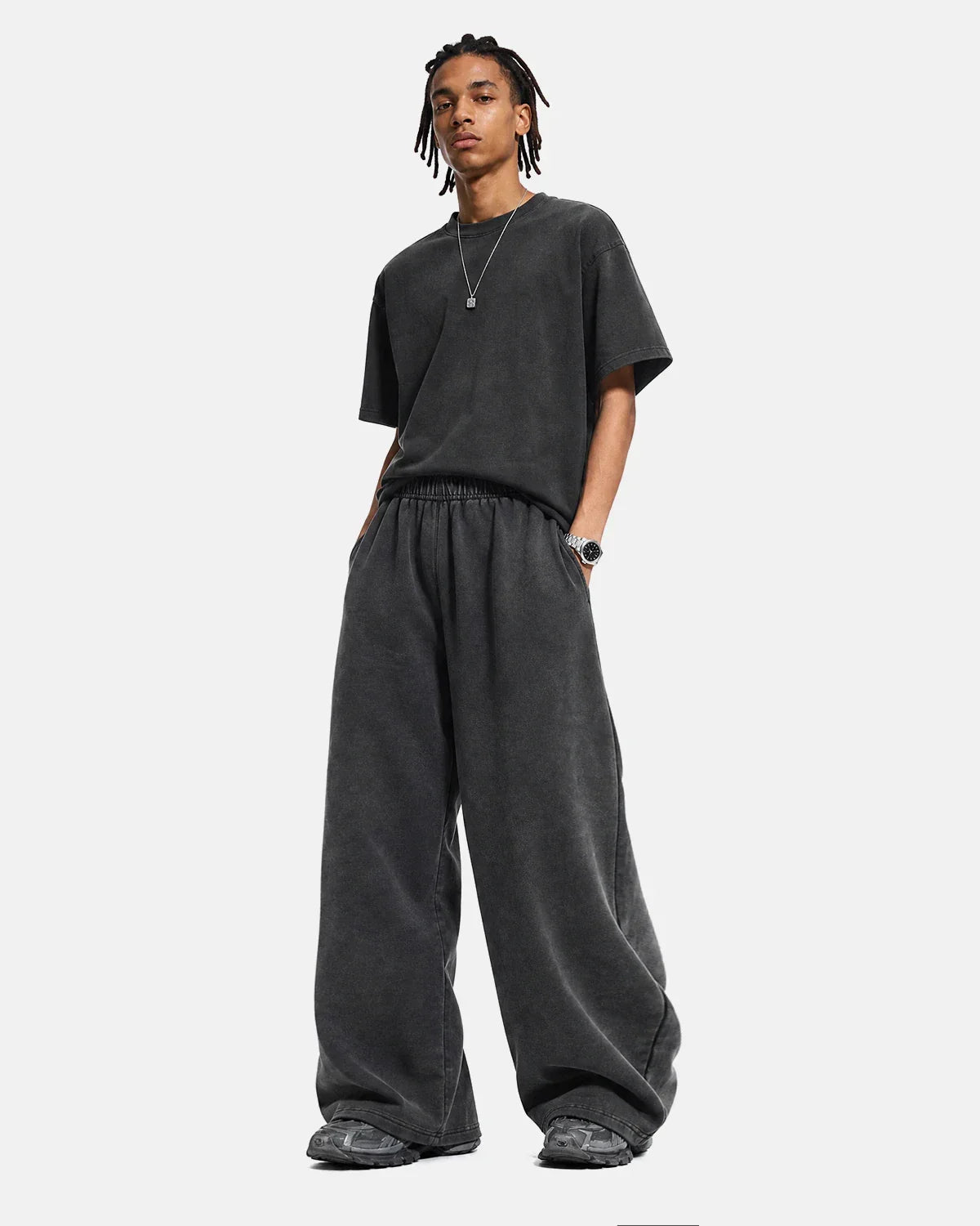 Washed graphic wide-leg sweatpants by INFLATION featuring a relaxed fit and streetwear style, shown on a model.