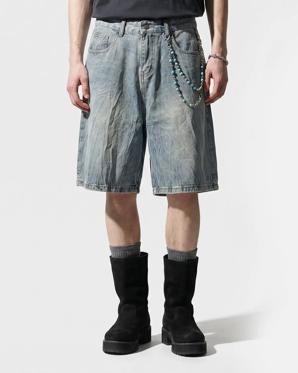 Textured washed longline jorts by INFLATION Streetwear, showing distressed denim pants with a relaxed, longline fit.