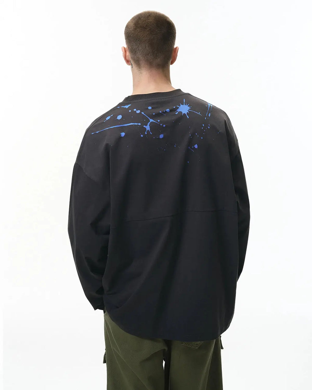 Laser burning design on black Flation streetwear T-shirt, featuring bold graphic artwork for urban fashion style.