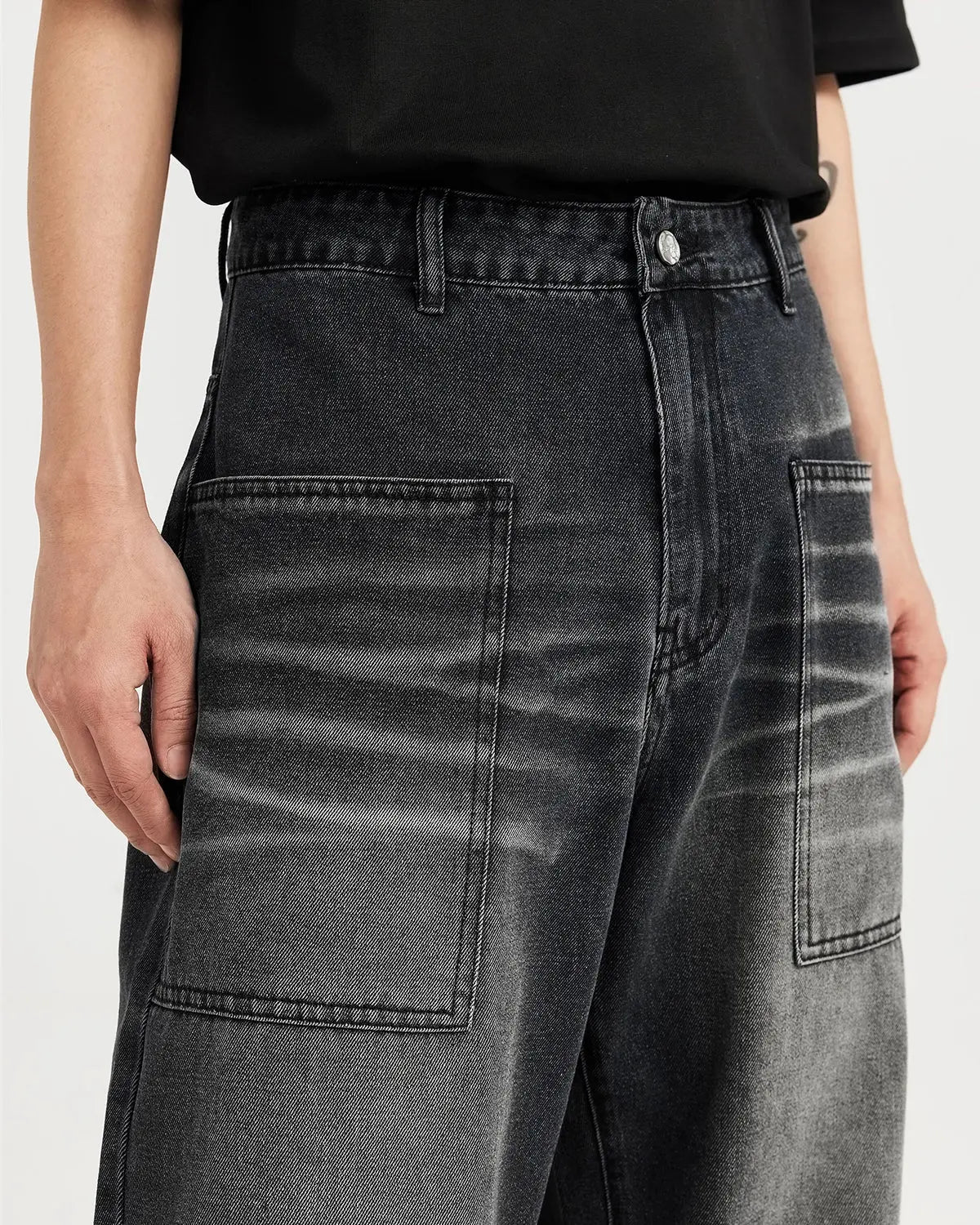Black washed baggy jeans from Flation Streetwear, featuring relaxed fit and distressed denim style.