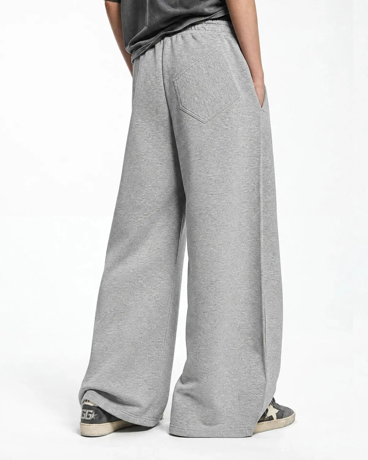 Inflation Streetwear curved wide-leg sweatpants in soft fabric, featuring a relaxed fit and stylish design, shown on a model.