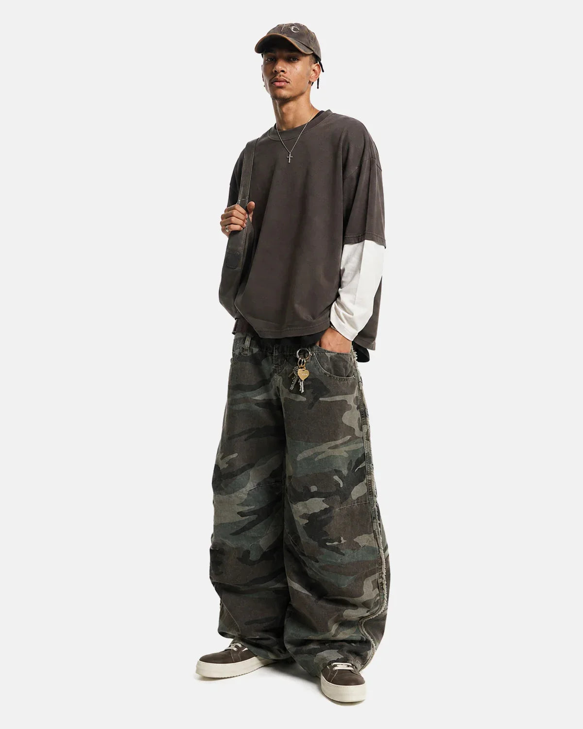 Inflation Streetwear double waist camo cargo pants with multiple pockets and relaxed fit, featuring green and brown camouflage pattern.