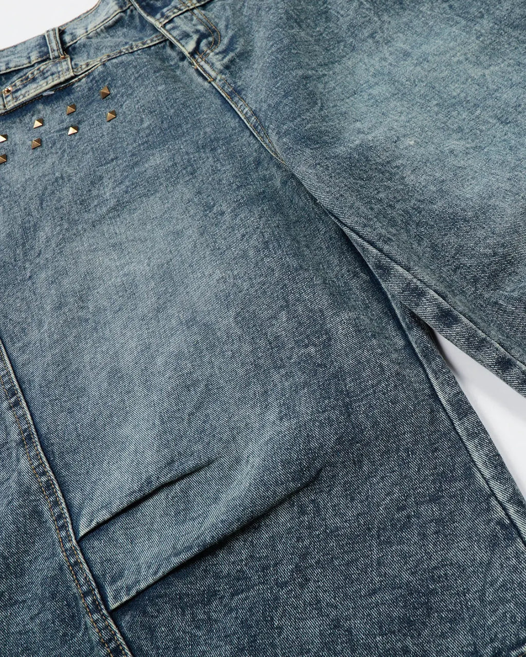 Inflation Streetwear studded washed long baggy jorts pants with distressed details and metal stud accents, casual streetwear style.