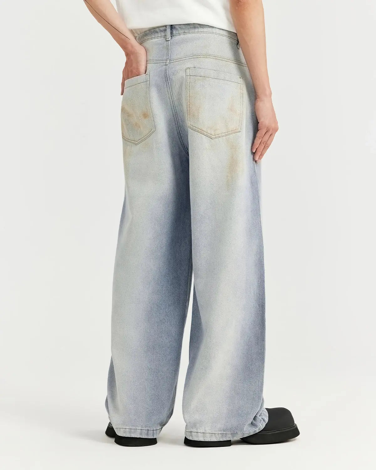 Mud washed baggy jeans by Flation Streetwear with a relaxed fit and faded, textured denim look.