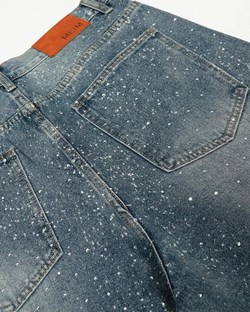 Rhinestone-studded straight-leg denim jeans from INFLATION streetwear, featuring a classic blue wash and fitted silhouette.
