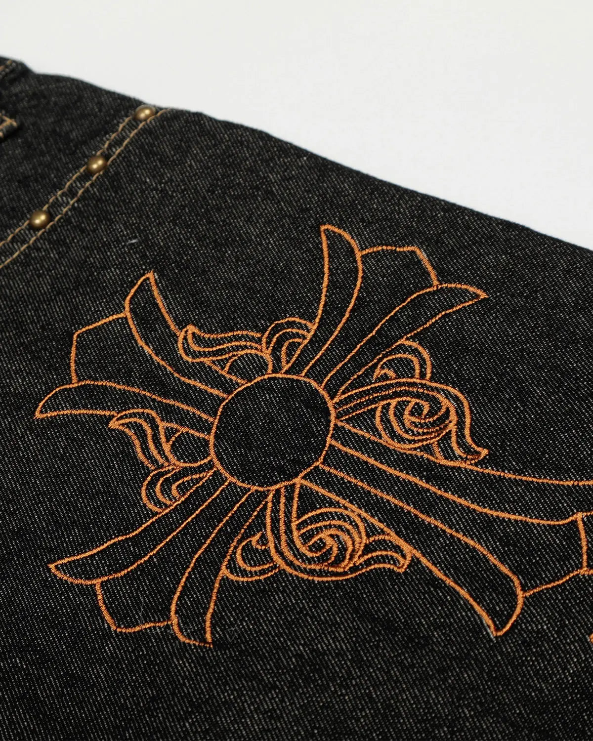 Dark blue Gothic Cross embroidery on Inflation Streetwear barrel jeans, showcasing detailed cross designs on the denim.
