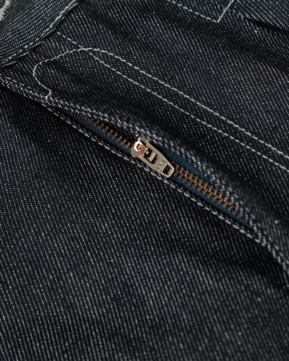 Raw baggy jeans with contrast stitching by INFLATION Streetwear, showing relaxed fit and distressed denim details.