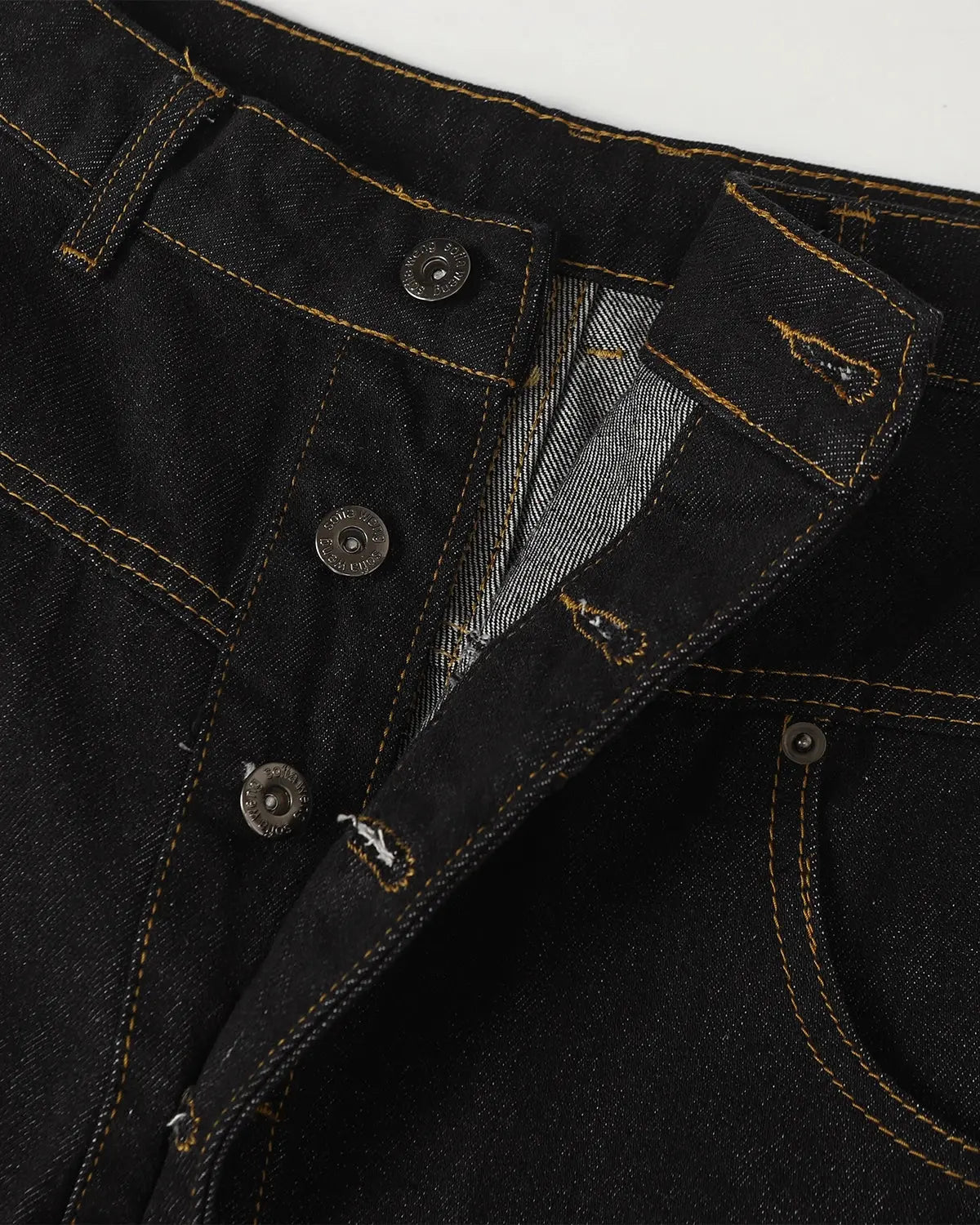 Inflation Buttons Up Raw Baggy Jeans featuring a loose fit, button fly, and distressed denim style in a raw denim finish.