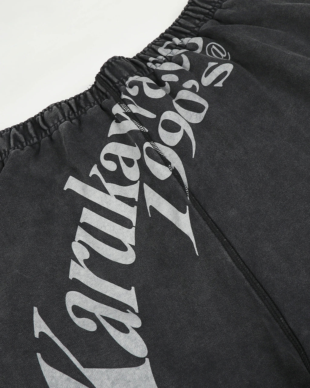 Washed graphic wide-leg sweatpants from INFLATION Streetwear, showing the relaxed fit and faded graphic details.