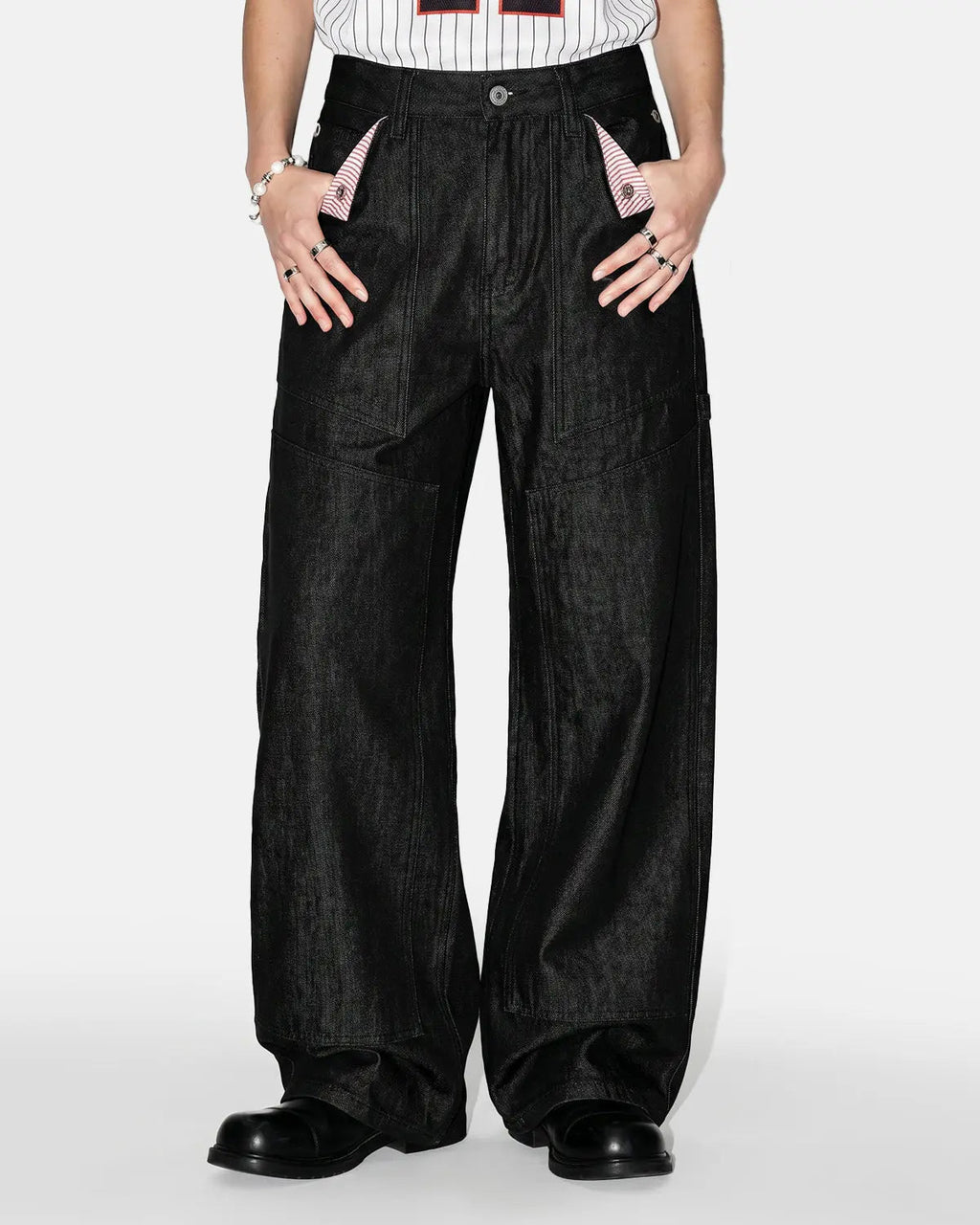 Deconstructed utility baggy jeans by INFLATION featuring oversized fit, multiple pockets, and distressed denim details.
