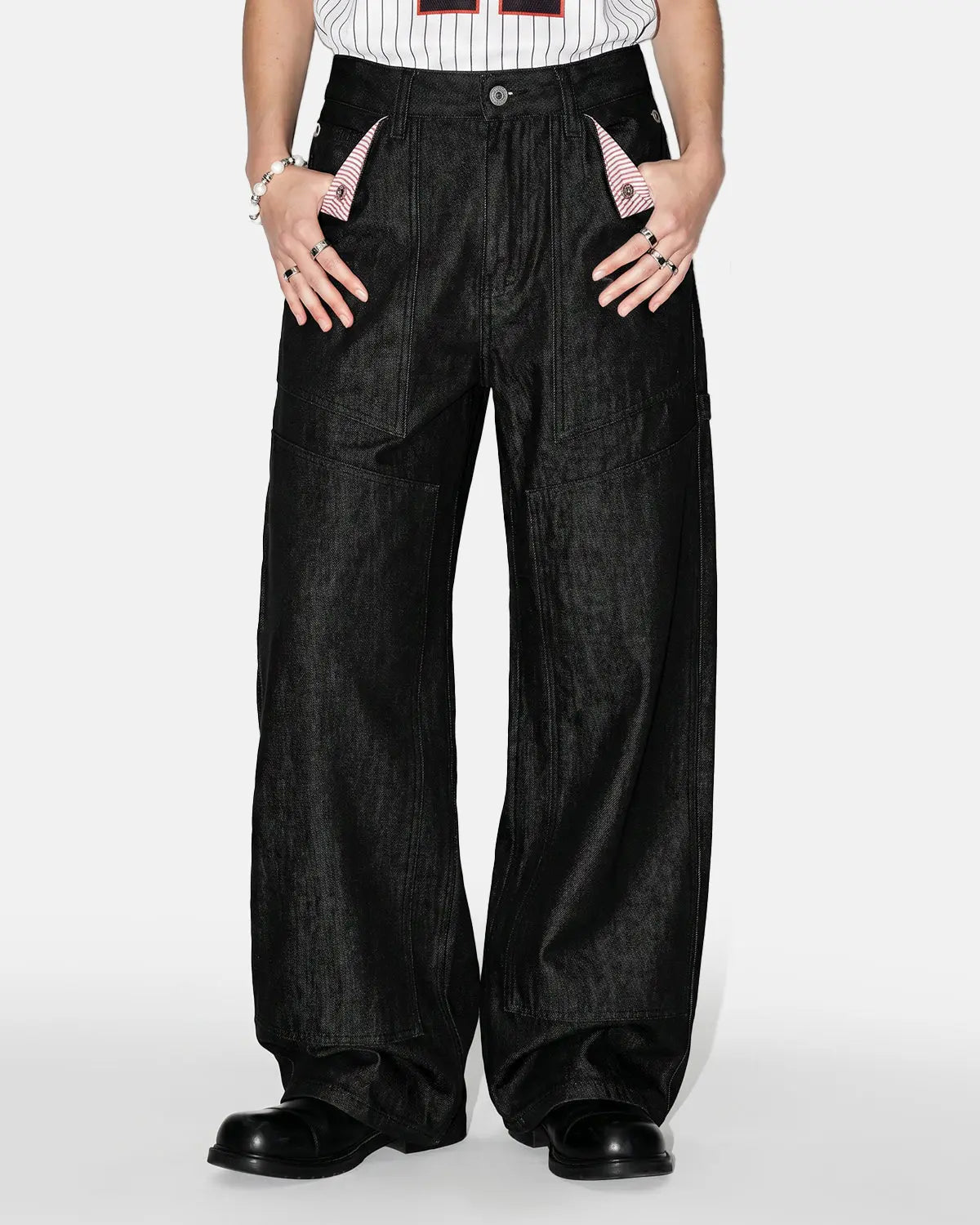 Deconstructed utility baggy jeans by INFLATION featuring oversized fit, multiple pockets, and distressed denim details.
