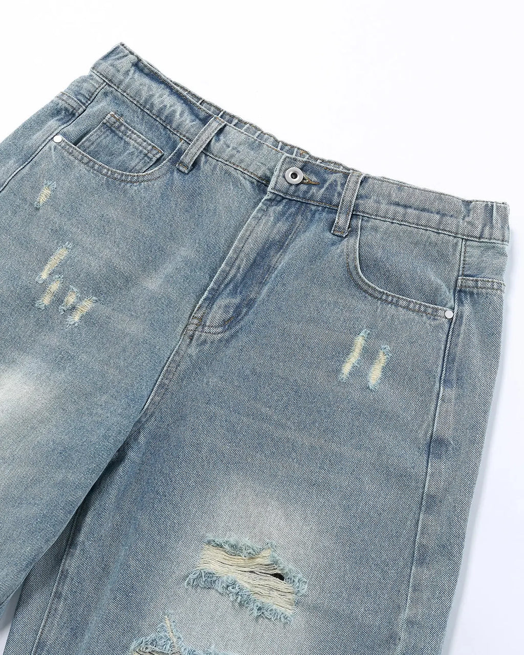 Vintage wash distressed baggy jeans by INFLATION, featuring ripped details and relaxed fit, styled for streetwear fashion.