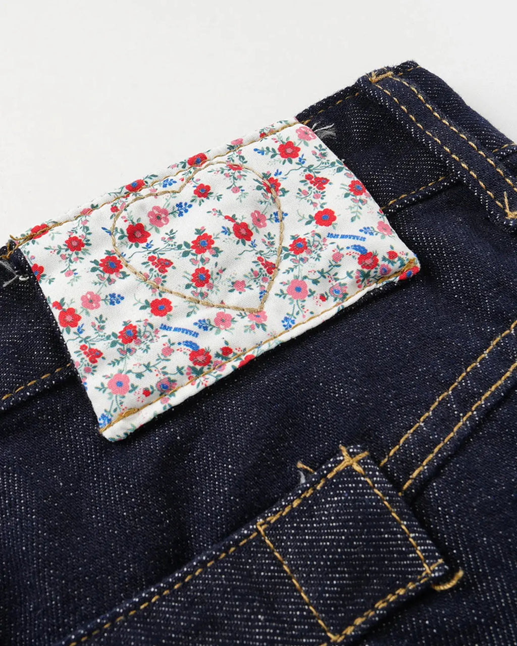 Inflation Selvedge Buckle Baggy Jeans displayed on a model, showcasing their relaxed fit, unique buckle details, and raw denim texture.