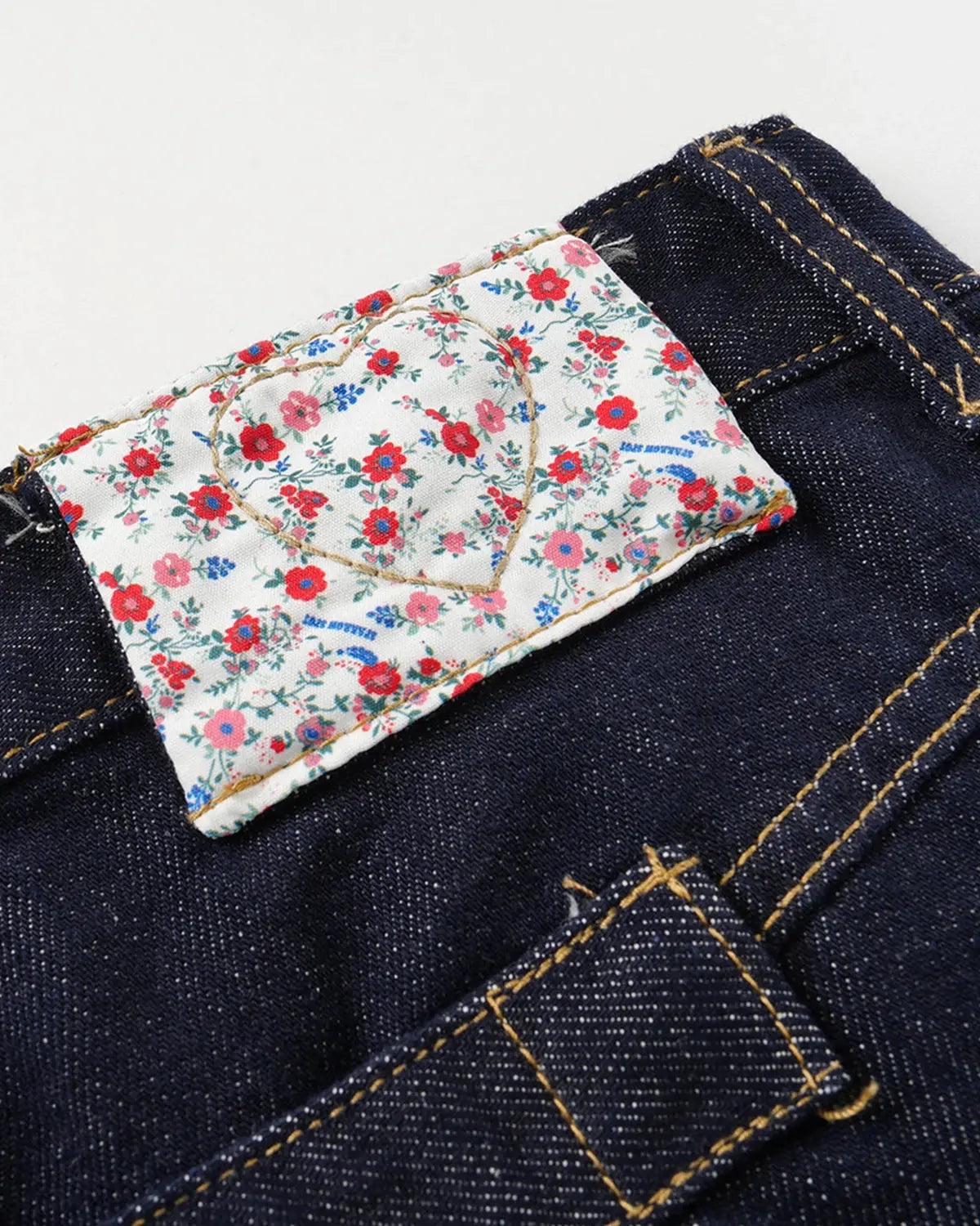Inflation Selvedge Buckle Baggy Jeans displayed on a model, showcasing their relaxed fit, unique buckle details, and raw denim texture.