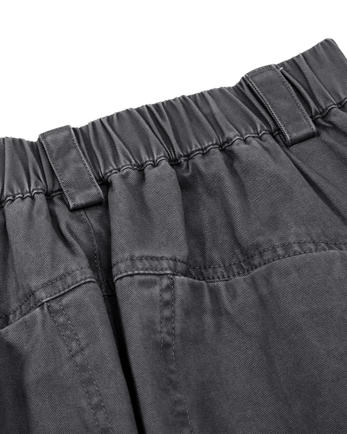 Washed curved seam cargo pants by INFLATION, featuring a relaxed fit with curved seams and multiple cargo pockets.