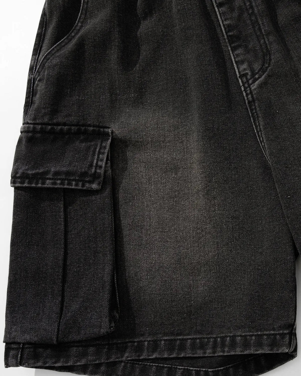 Inflation brand washed denim cargo shorts with drawstring, featuring multiple pockets and a casual streetwear style.
