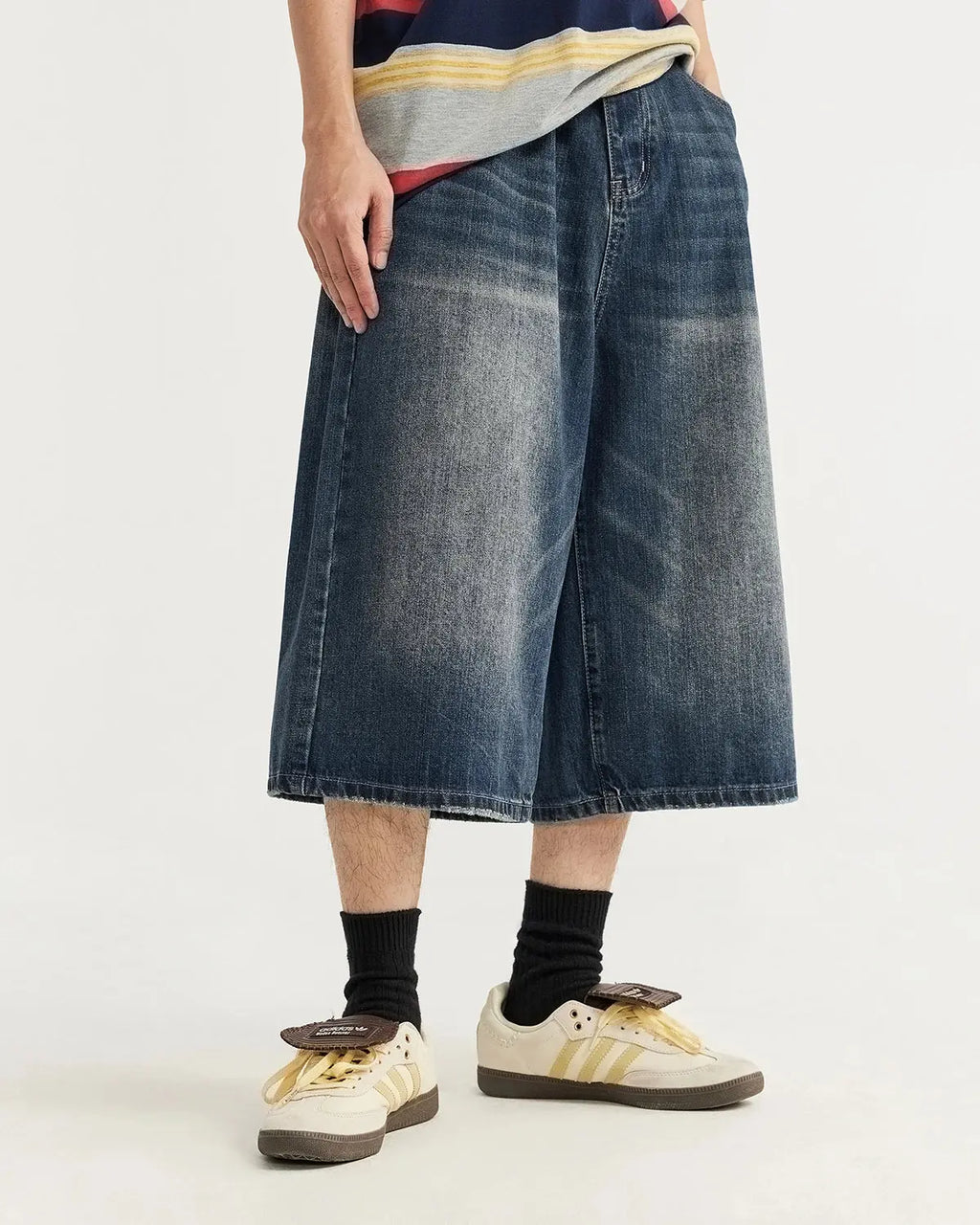 Acid washed longline baggy denim jorts by INFLATION, showcasing relaxed fit and distressed detailing in a streetwear style.
