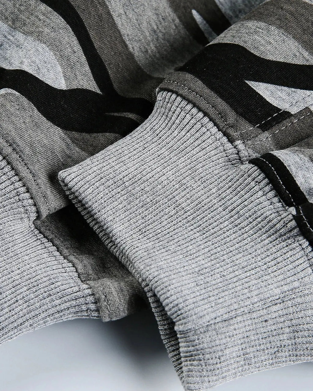Cropped camouflage zip-up hoodie by INFLATION featuring a military print, front zipper, and casual streetwear style.