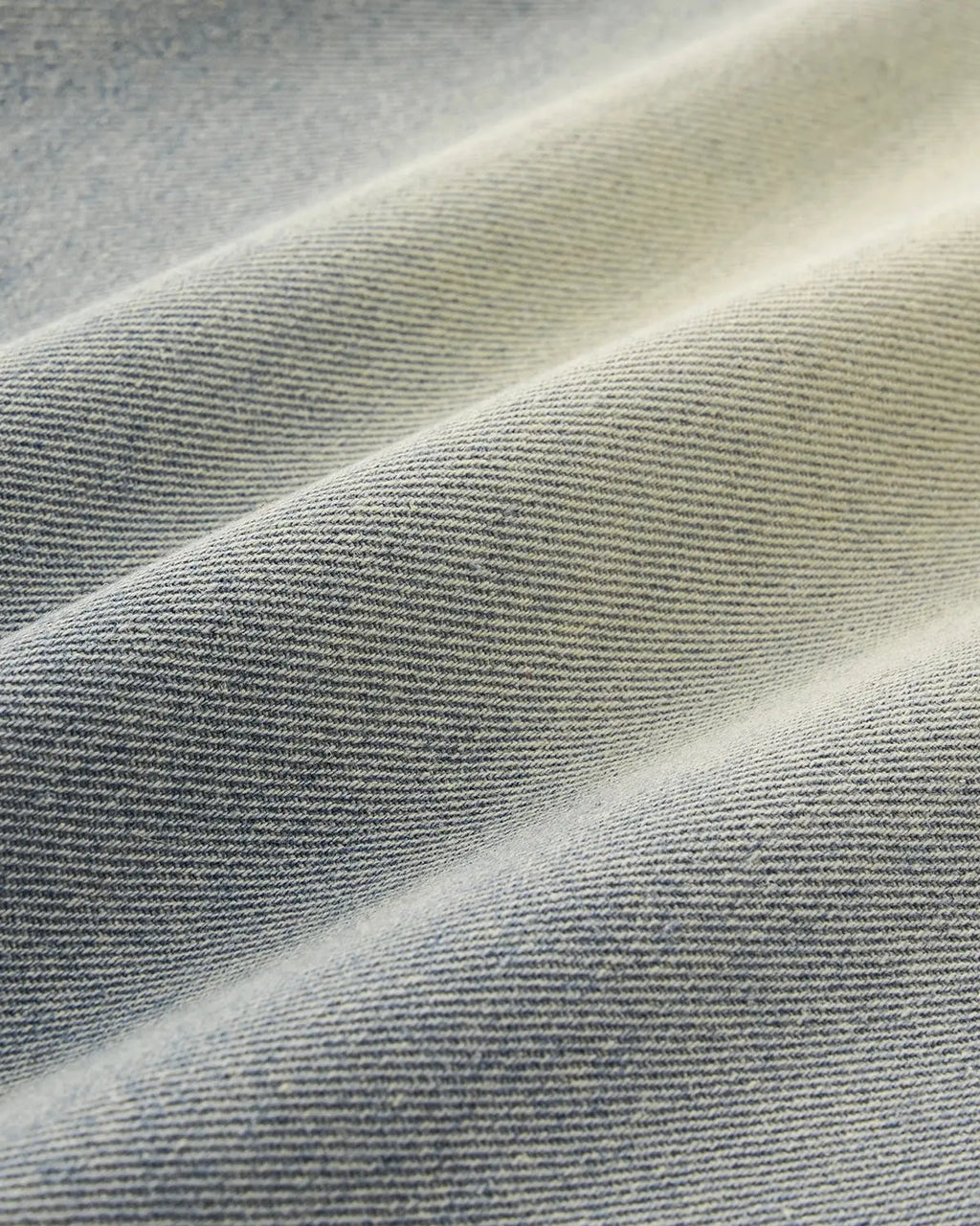 Acid washed super baggy jeans by Flation Streetwear, showing the relaxed fit and distressed denim fabric.