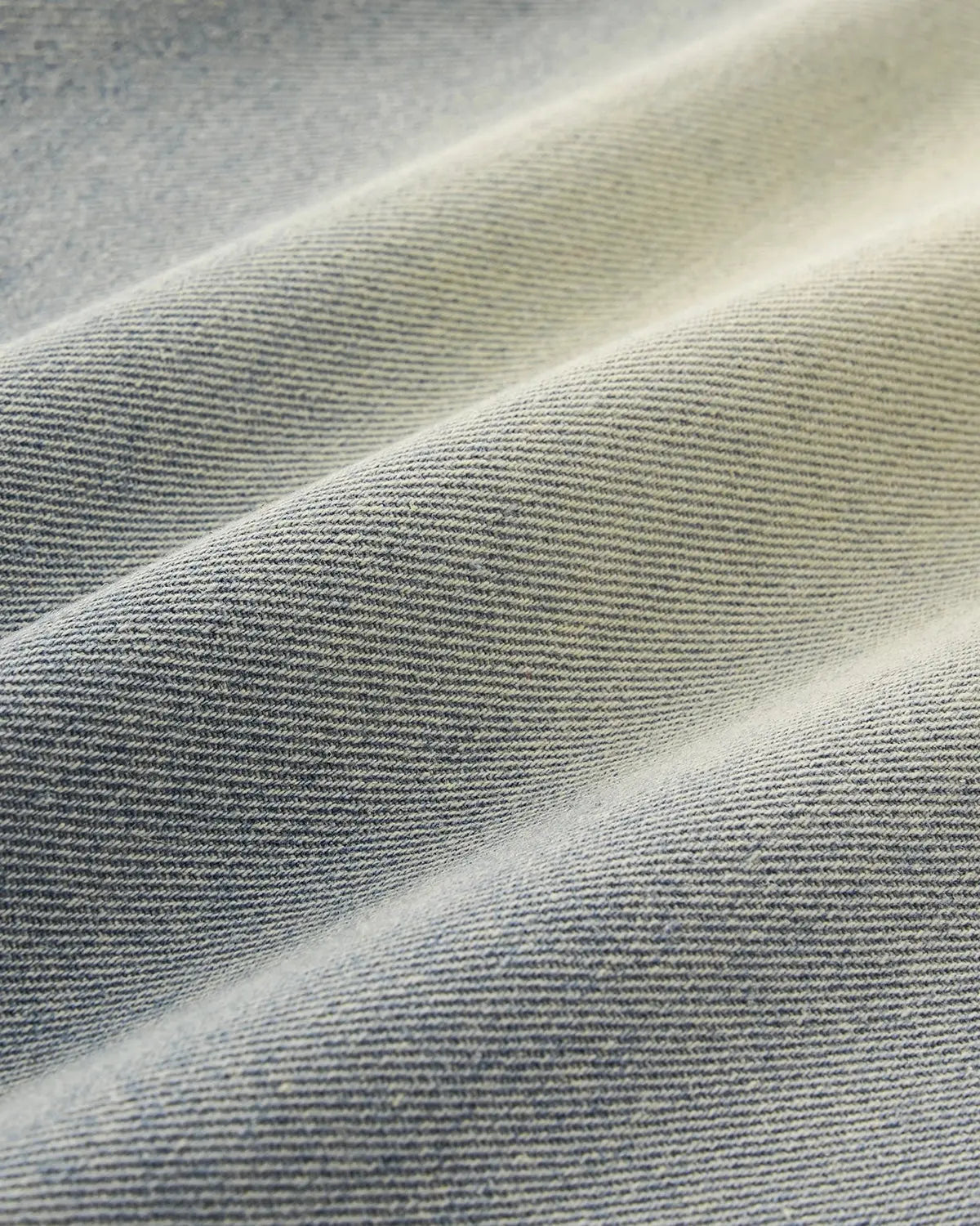 Acid washed super baggy jeans by Flation Streetwear, showing the relaxed fit and distressed denim fabric.