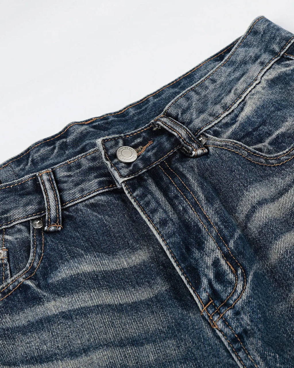Distressed baggy jeans from Inflation Streetwear's Whisker Wash collection, featuring a relaxed fit and faded detailing.
