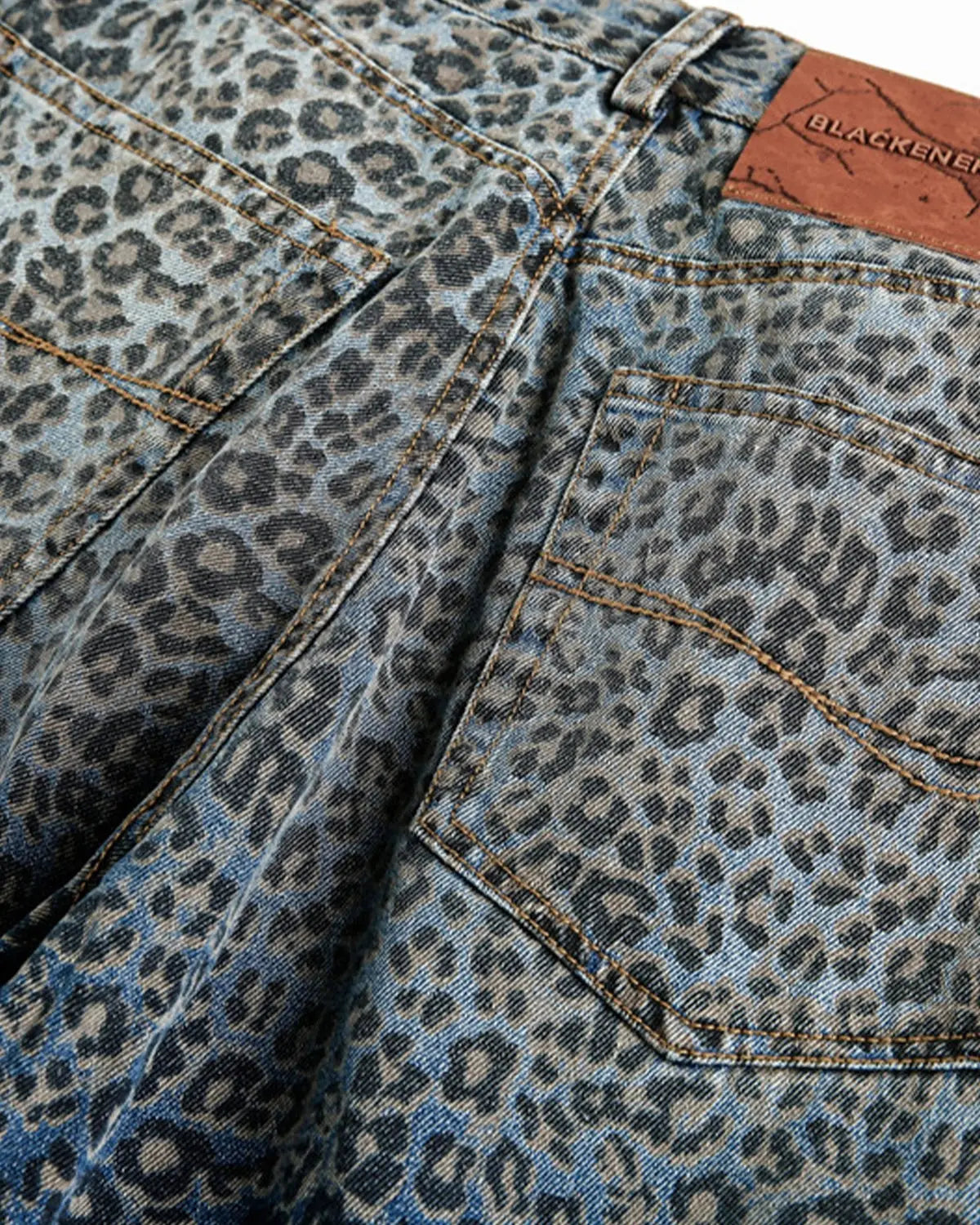 Vintage leopard print barrel jeans by INFLATION featuring bold animal print and relaxed fit, perfect for streetwear style.