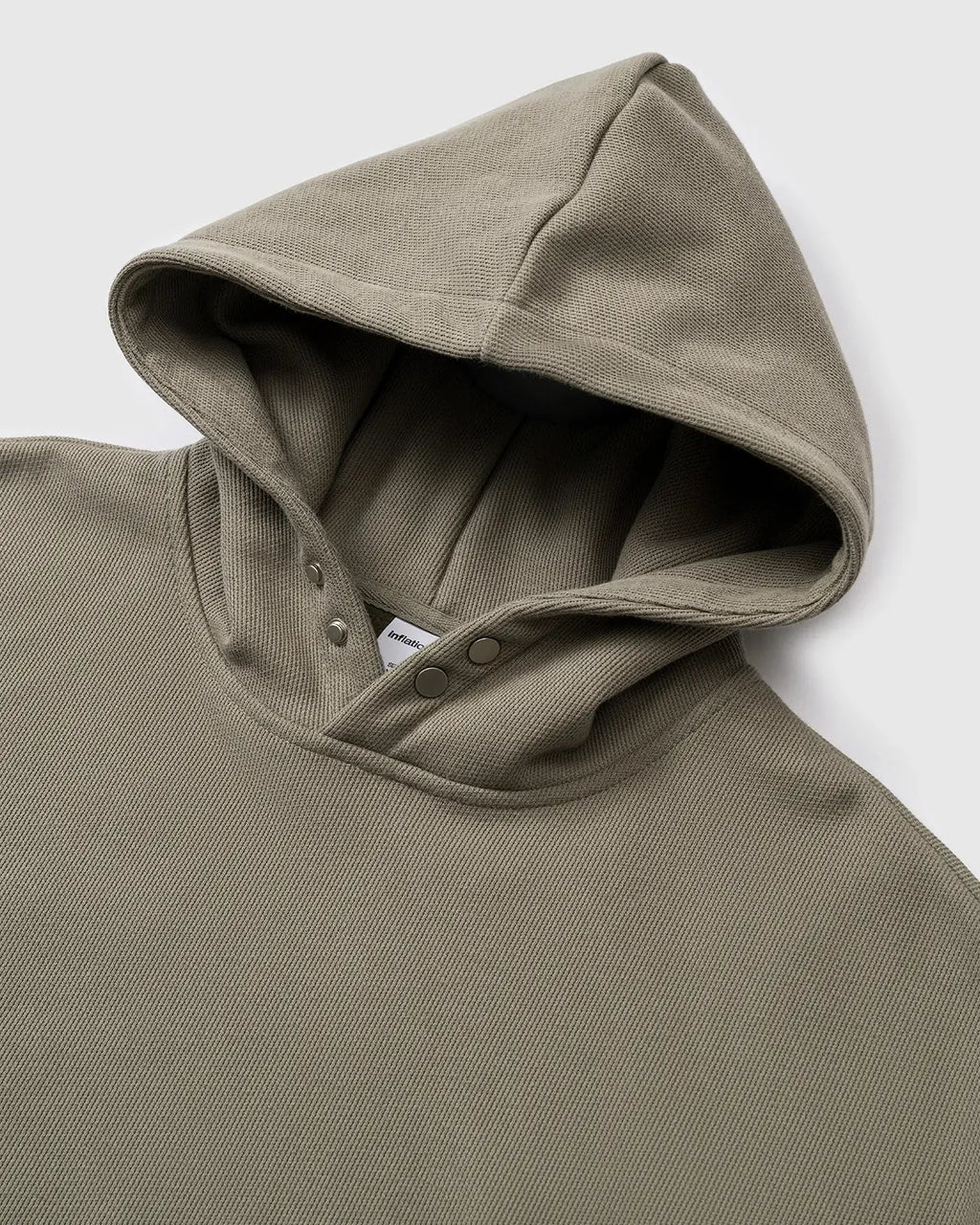 Inflation Streetwear boxy cropped hoodie in neutral color, showcasing its relaxed fit and stylish design.